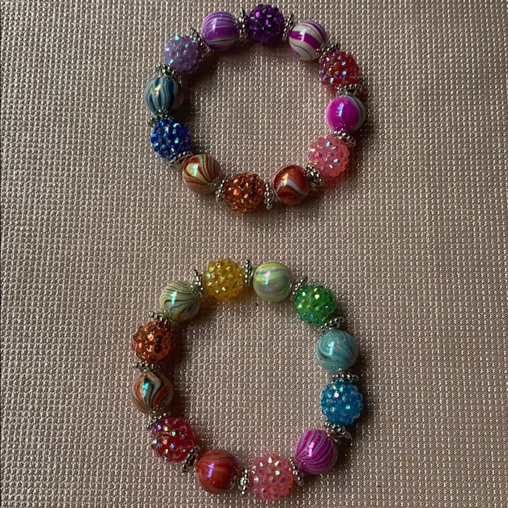Two multi colored bracelets.